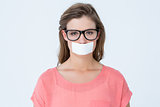 Geeky hipster with adhesive tape on mouth