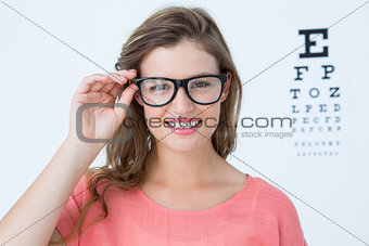 Pretty hipster with glasses and eye test