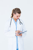 Smiling doctor pointing tablet pc