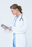 Serious doctor using tablet pc