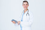 Happy doctor holding tablet pc