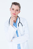 Thoughtful doctor looking at camera with hand on chin