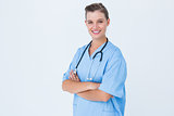 Happy nurse looking at camera with arms crossed