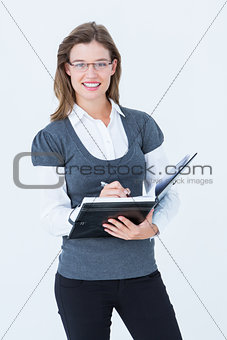 Happy woman writing in diary