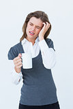 Woman with headache holding mug