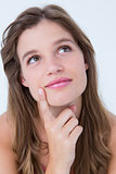 Thoughtful woman with finger on chin