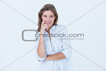 Smiling woman biting her finger