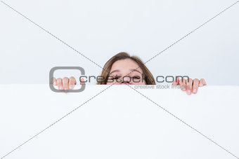 Woman looking top of poster