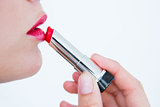 Woman putting red lipstick