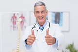 Happy doctor looking at camera with thumbs up