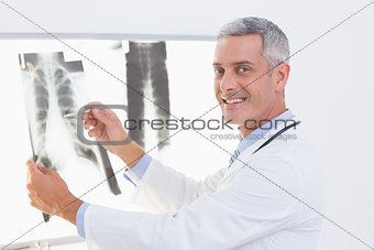 Smiling doctor looking at X-Rays