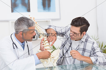 Doctor explaining the spine to a patient
