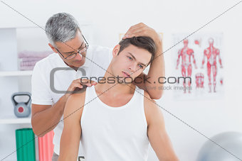 Doctor doing neck adjustment
