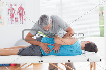 Doctor examining man back