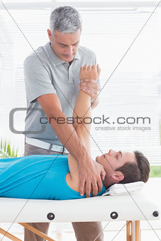 Doctor examining his patient arm