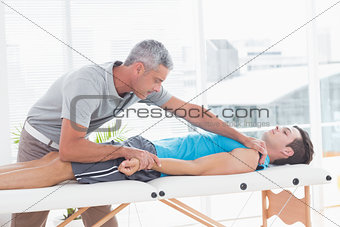 Doctor stretching his patient arm