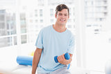 Young man training with dumbbell
