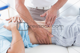 Doctor examining his patient stomach