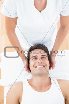 Smiling man receiving neck massage
