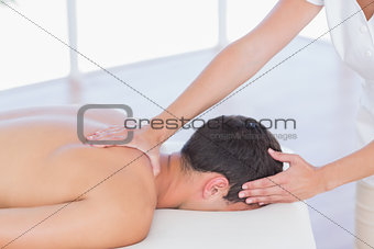 Physiotherapist doing shoulder massage to her patient