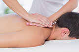 Physiotherapist doing back massage to her patient
