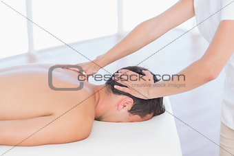 Physiotherapist doing neck massage to her patient
