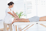 Physiotherapist doing calf massage to her patient