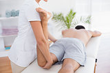 Physiotherapist doing leg massage to her patient