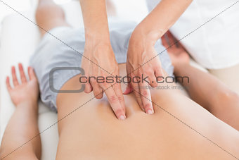 Physiotherapist doing back massage to her patient
