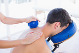Man having back massage with massage ball