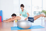 Trainer with man on exercise ball