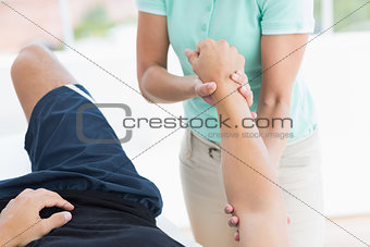 Doctor examining man arm