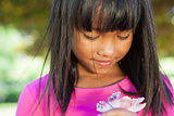 Cute little girl holding flower