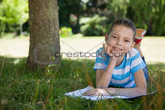 Cute little girl reading in park