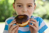 Cute little girl eating doughnut