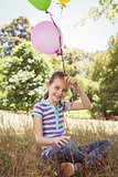 Cute little girl holding balloons