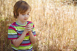 Praying little boy in the park