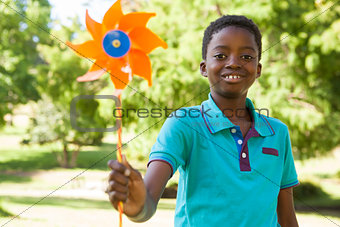 Happy boy in the park with pinwheel