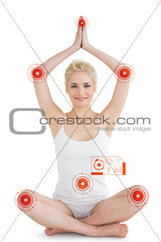 Composite image of toned young woman sitting with joined hands over head