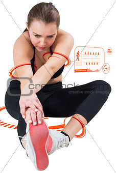 Composite image of fit brunette stretching her leg