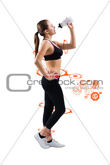 Composite image of fit brunette drinking from sports bottle