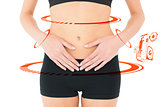 Composite image of closeup mid section of a fit woman with stomach pain