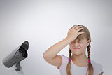 Composite image of little girl suffering from headache and touching her head
