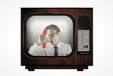 Composite image of angry geeky businessman holding telephone