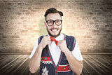 Composite image of geeky hipster wearing christmas vest