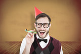 Composite image of geeky hipster in party hat with horn