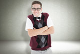 Composite image of smiling geeky hipster looking at camera