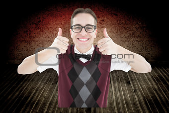 Composite image of smiling geeky hipster looking at camera showing thumbs up