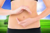Composite image of closeup mid section of a fit woman with hand gestures