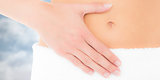Composite image of mid section of a fit woman with hand on stomach